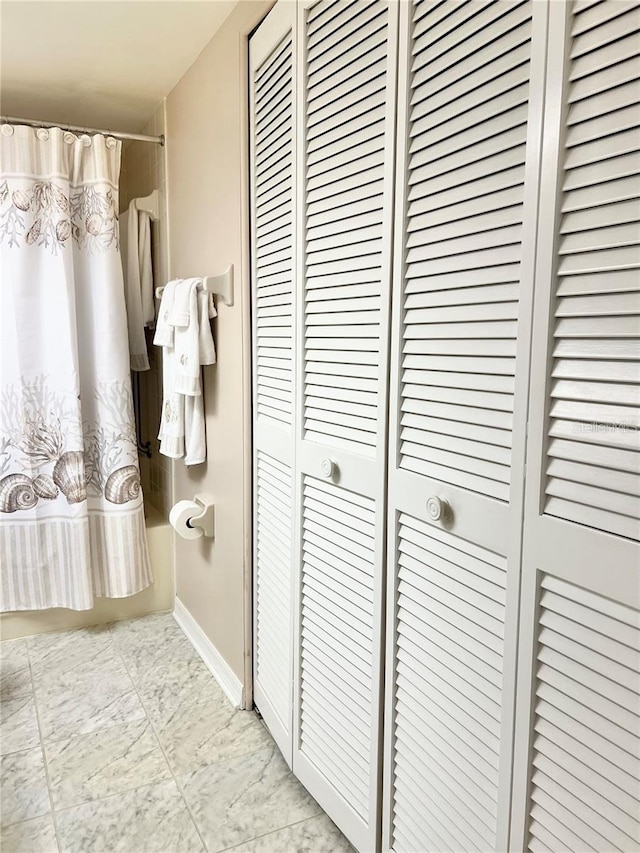 bathroom with shower / bath combination with curtain