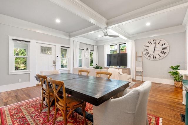 dining space with coffered ceiling, hardwood / wood-style flooring, ceiling fan, ornamental molding, and beamed ceiling