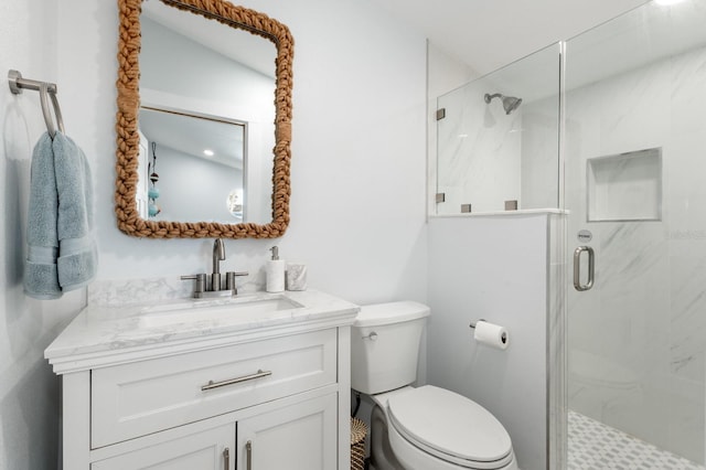 bathroom with vanity, toilet, and an enclosed shower