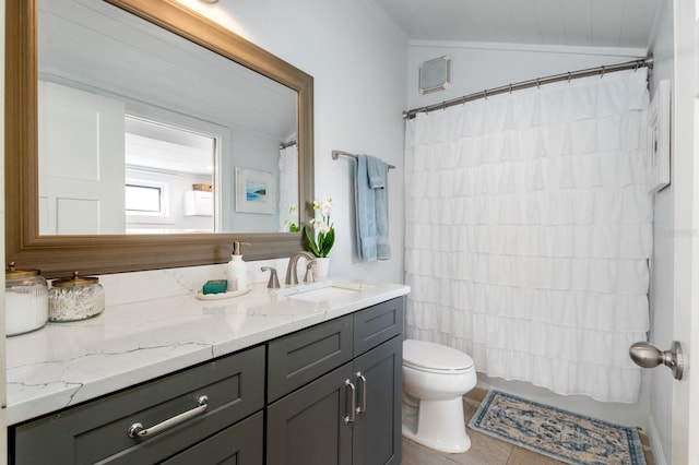 bathroom featuring tile patterned flooring, vanity, toilet, and lofted ceiling