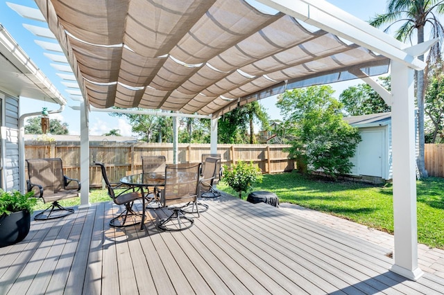 wooden deck featuring a pergola and a lawn