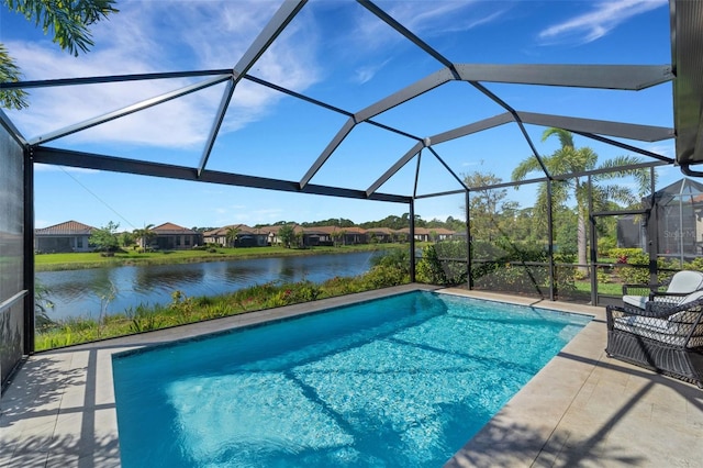 view of swimming pool with a water view, glass enclosure, and a patio area