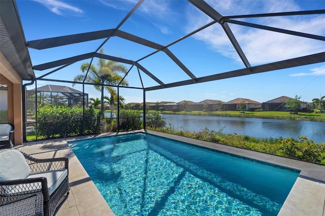 view of swimming pool with a patio, a water view, and glass enclosure