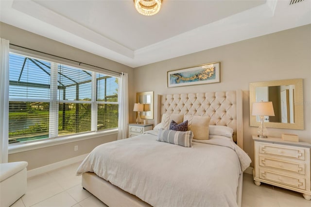 bedroom featuring a raised ceiling and light tile patterned floors