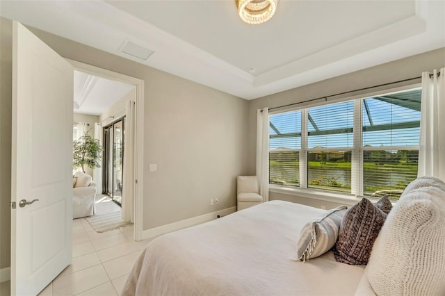 tiled bedroom with a raised ceiling