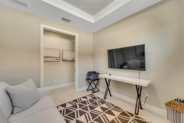 interior space featuring a raised ceiling and ornamental molding