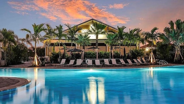 view of pool at dusk