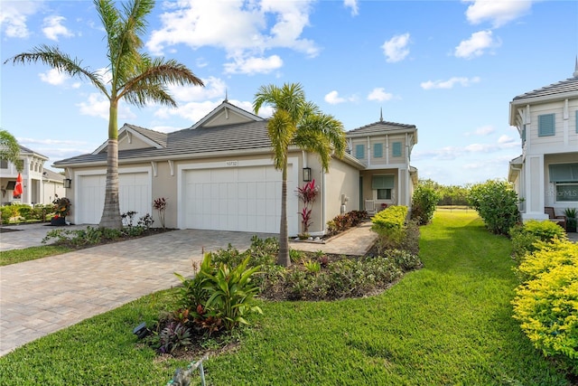 view of front of property featuring a garage and a front lawn