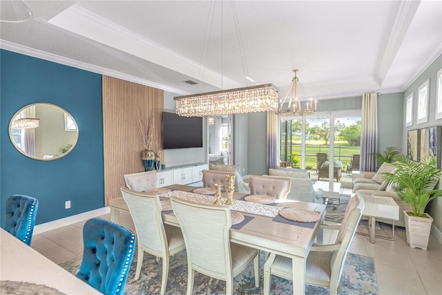 tiled dining space with a tray ceiling, crown molding, and a chandelier