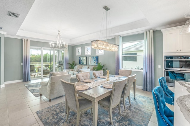 dining space featuring a raised ceiling, crown molding, light tile patterned floors, and a chandelier