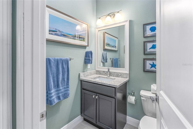 bathroom with tile patterned floors, vanity, and toilet