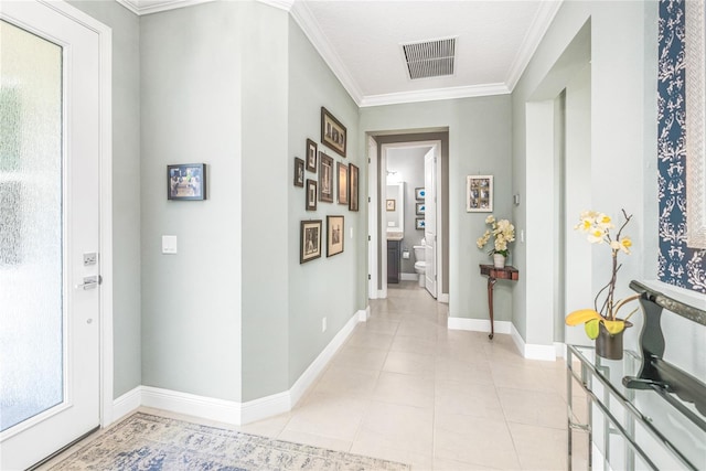 tiled foyer entrance featuring a textured ceiling and ornamental molding