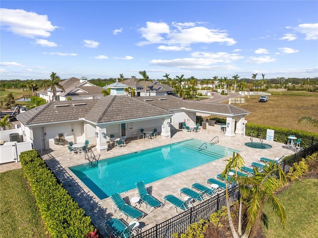 view of swimming pool featuring a yard and a patio