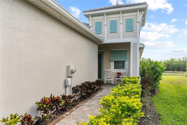 entrance to property with a lawn