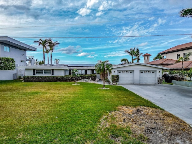 view of front facade featuring a garage, a front yard, and solar panels