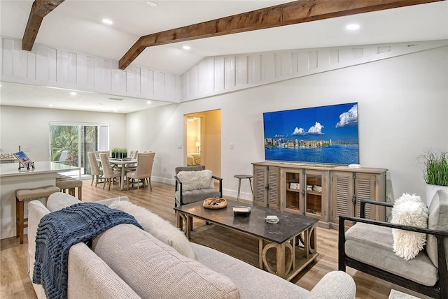 living room with lofted ceiling with beams and light wood-type flooring