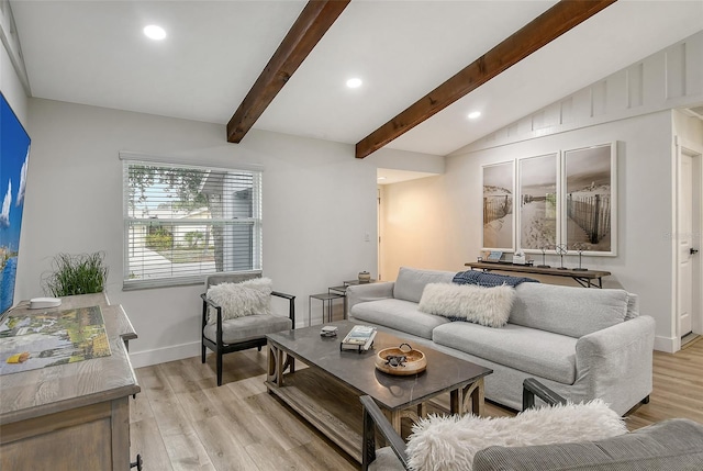 living room with vaulted ceiling with beams and light wood-type flooring