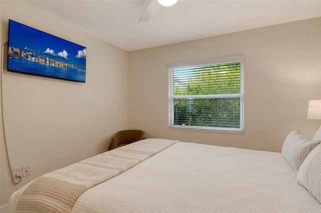 bedroom with multiple windows and ceiling fan