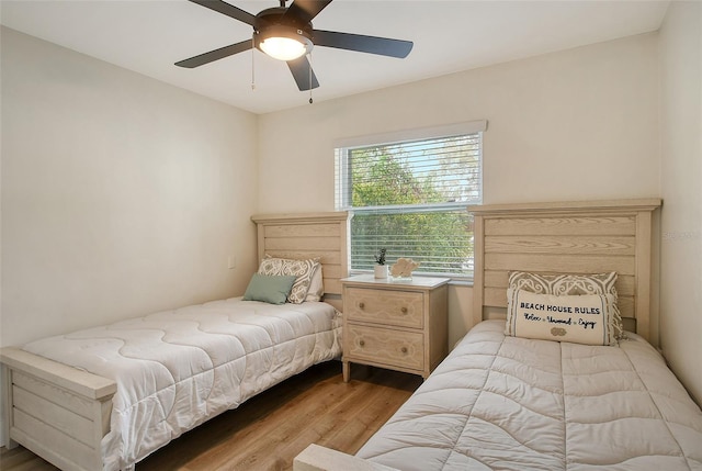 bedroom with light hardwood / wood-style floors and ceiling fan