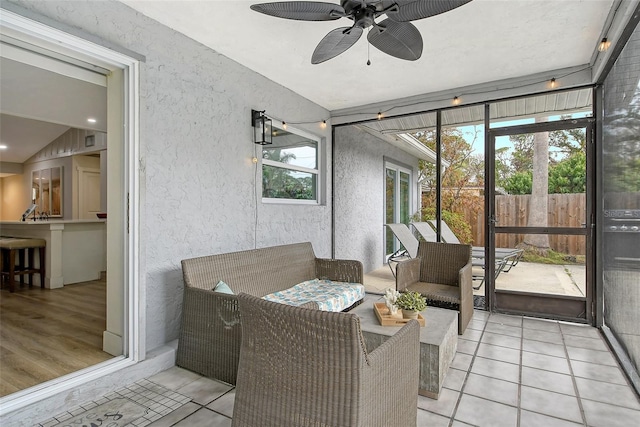 sunroom with ceiling fan and lofted ceiling