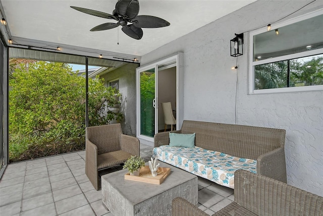 sunroom / solarium featuring ceiling fan