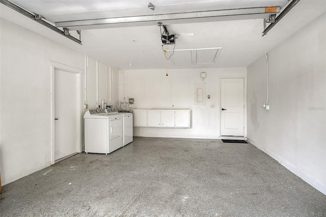 garage with a garage door opener and washing machine and clothes dryer