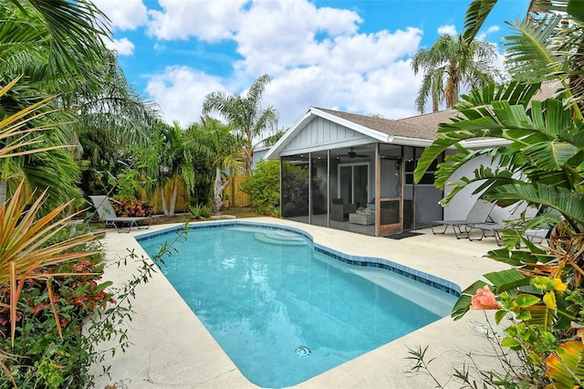 view of pool with a patio, ceiling fan, and a sunroom