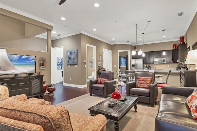 living room featuring ceiling fan, ornamental molding, and light hardwood / wood-style flooring