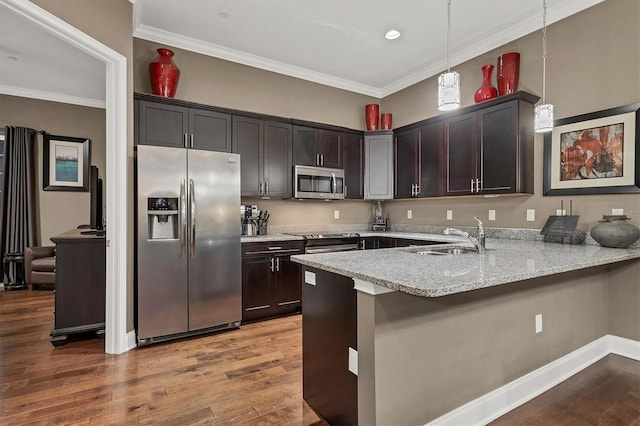 kitchen featuring sink, kitchen peninsula, crown molding, pendant lighting, and appliances with stainless steel finishes