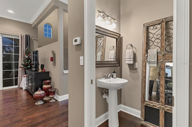 bathroom featuring hardwood / wood-style floors, sink, and crown molding