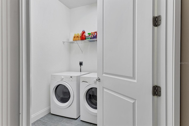 clothes washing area with light tile patterned flooring and independent washer and dryer