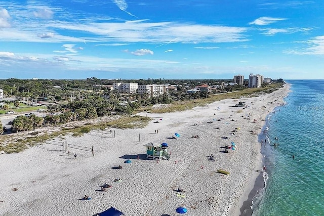 drone / aerial view featuring a water view and a view of the beach