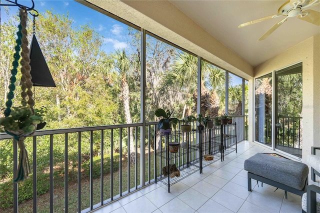 unfurnished sunroom featuring ceiling fan