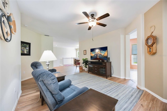 living room featuring ceiling fan and light wood-type flooring