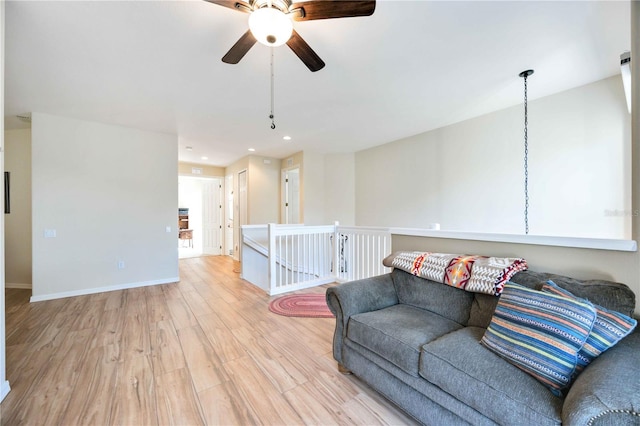 living room featuring light hardwood / wood-style floors and ceiling fan