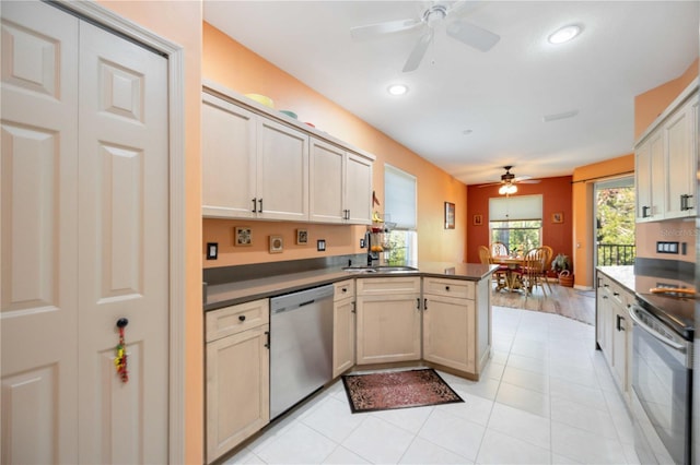 kitchen with ceiling fan, sink, stainless steel dishwasher, kitchen peninsula, and range