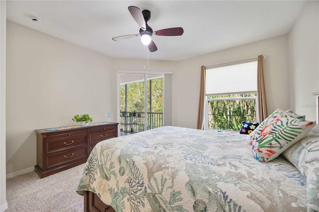 bedroom with access to exterior, ceiling fan, and light colored carpet