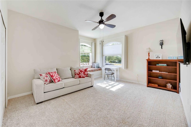 living room with ceiling fan and carpet