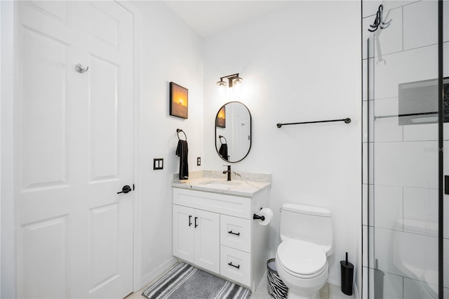 bathroom with an enclosed shower, vanity, and toilet