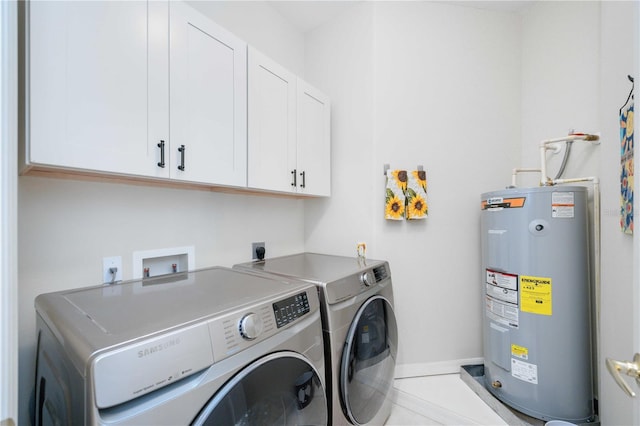 laundry area featuring tile patterned floors, electric water heater, washer and clothes dryer, and cabinets