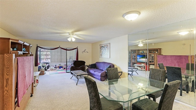 carpeted dining space with ceiling fan and a textured ceiling