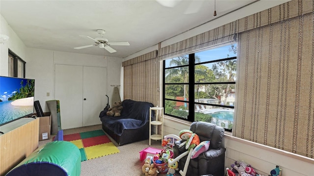 playroom with ceiling fan and plenty of natural light