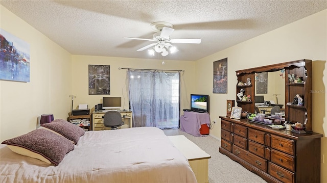 bedroom with a textured ceiling, light colored carpet, and ceiling fan