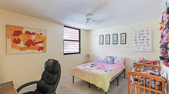 bedroom featuring carpet flooring, ceiling fan, and a textured ceiling