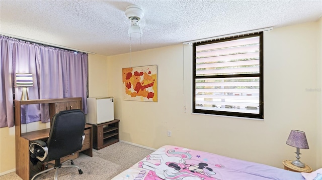 bedroom featuring light colored carpet and a textured ceiling