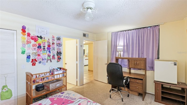 bedroom with a textured ceiling and light carpet