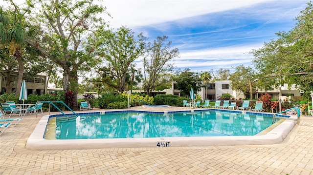 view of pool featuring a patio and a hot tub