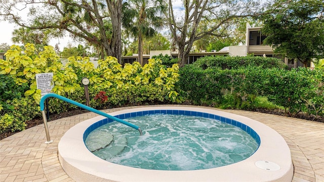 view of pool with a hot tub