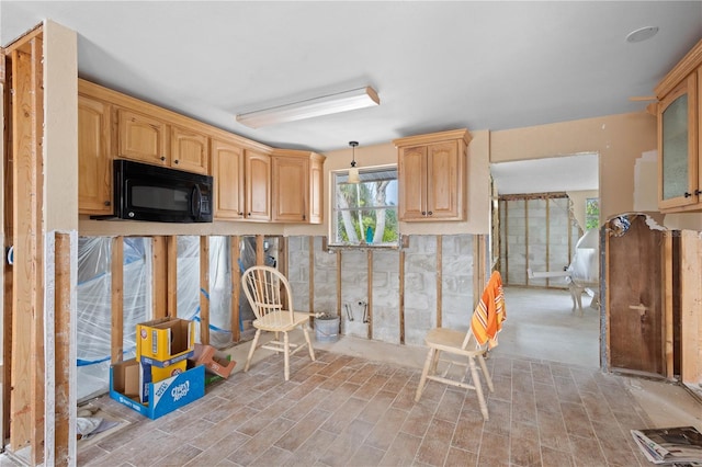 kitchen featuring pendant lighting and light brown cabinetry