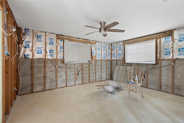 basement featuring carpet flooring and ceiling fan